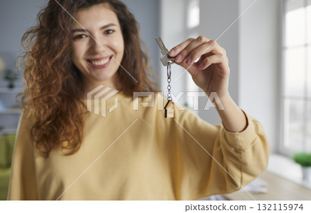 Attractive young woman holding keys to her new apartment 132115974