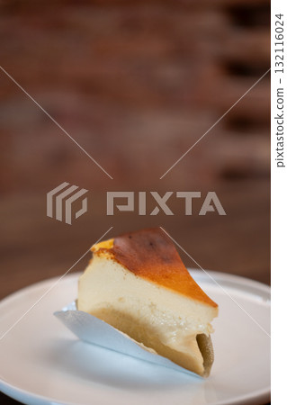 Burnt Basque cheesecake served on plate on the table Burnt Basque cheesecake served on plate on the table 132116024