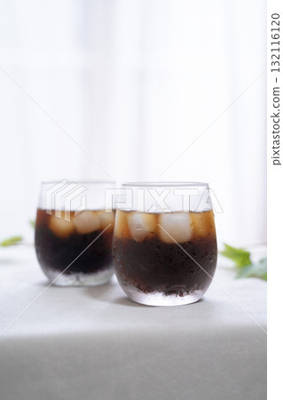 Iced coffee and houseplants on the windowsill Iced coffee and houseplants on the windowsill 132116120