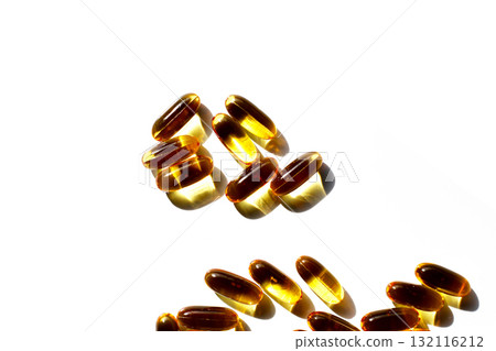 Golden fish oil capsules on white background. Golden fish oil capsules on white background. 132116212