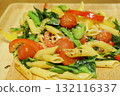 Italian-style dish of stir-fried tomatoes, komatsuna, and pasta 132116337