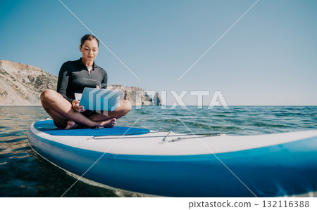 Woman Laptop Paddleboard - Working Remotely on a Paddleboard at the Beach Woman Laptop Paddleboard - Working Remotely on a Paddleboard at the Beach 132116388