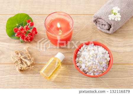 Towel with body care products and verbena flowers on the wooden background. 132116879