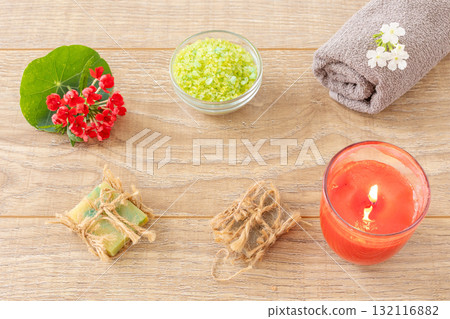 Towel with body care products and verbena flowers on the wooden background. Towel with body care products and verbena flowers on the wooden background. 132116882