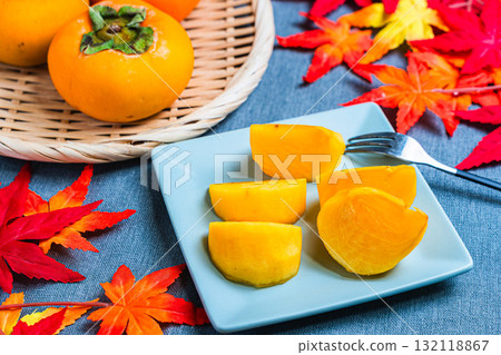 Seedless persimmons and autumn leaves Seedless persimmons and autumn leaves 132118867