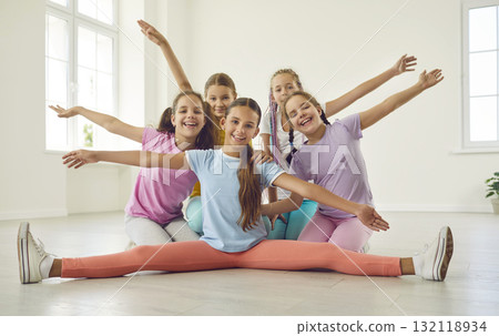 Cheerful happy girls dancers having fun in choreography class, posing and looking at camera. Cheerful happy girls dancers having fun in choreography class, posing and looking at camera. 132118934