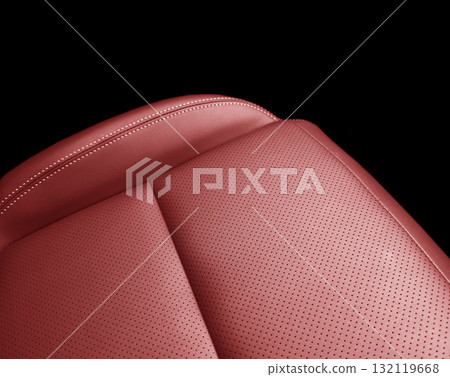 Car red leather interior. Part of red leather car seat details with white stitching. Interior of prestige car. Perforated leather seats isolated on black. Perforated leather. Car red leather interior. Part of red leather car seat details with white stitching. Interior of prestige car. Perforated leather seats isolated on black. Perforated leather. 132119668