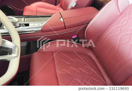 Modern luxury car brown leather interior. Part of orange leather car seat details with white stitching. Interior of prestige car. Comfortable perforated leather seats. Perforated leather. Modern luxury car brown leather interior. Part of orange leather car seat details with white stitching. Interior of prestige car. Comfortable perforated leather seats. Perforated leather. 132119693