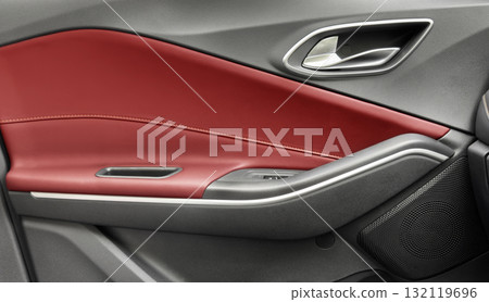 Door handle with Power window control buttons of a luxury passenger car. Red leather interior of the luxury modern car. Modern car interior details Door handle with Power window control buttons of a luxury passenger car. Red leather interior of the luxury modern car. Modern car interior details 132119696