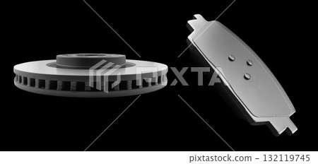 Car brake disc and brake pads isolated on black background. Auto spare parts. Perforated brake disc rotor isolated on black. Ventilated discs. Spare parts for car service or maintenance. Car brake disc and brake pads isolated on black background. Auto spare parts. Perforated brake disc rotor isolated on black. Ventilated discs. Spare parts for car service or maintenance. 132119745