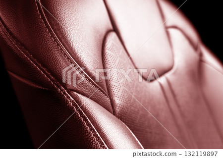 Car red leather interior. Part of red leather car seat details with white stitching. Interior of prestige car. Perforated leather seats isolated. Perforated leather. Car red leather interior. Part of red leather car seat details with white stitching. Interior of prestige car. Perforated leather seats isolated. Perforated leather. 132119897