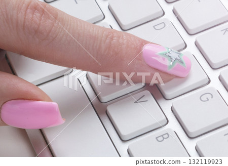 Closeup view of a business woman hand typing on wireless computer keyboard on office table. Soft lightning Closeup view of a business woman hand typing on wireless computer keyboard on office table. Soft lightning 132119923
