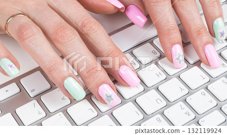 Closeup view of a business woman hands typing on wireless computer keyboard on office table 132119924