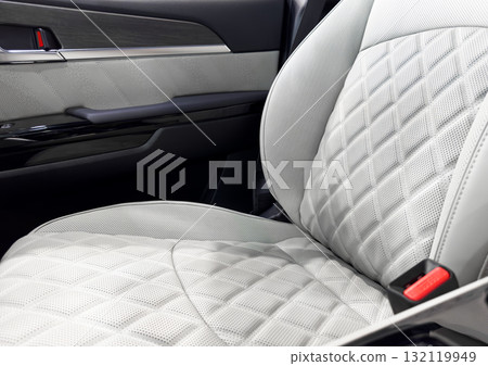 Car white leather interior. Part of white leather car seat details with white stitching. Interior of prestige car. Comfortable perforated leather seats. Perforated leather. 132119949