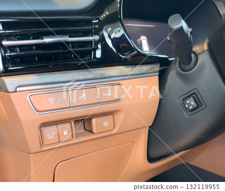 Luxury car brown leather interior. Part of brown leather car seat details with stitching isolated on black. Interior of prestige car. Comfortable perforated leather seats. Perforated leather. Luxury car brown leather interior. Part of brown leather car seat details with stitching isolated on black. Interior of prestige car. Comfortable perforated leather seats. Perforated leather. 132119955