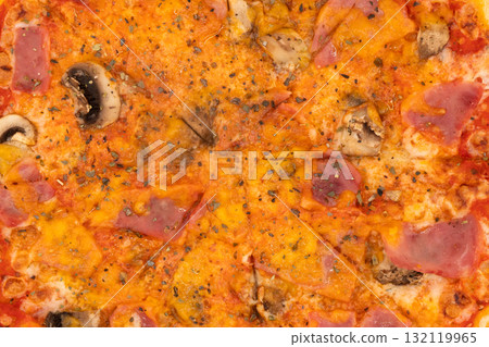 Tasty pizza with ham and mushrooms texture background. Sliced ham pizza overhead view. Tasty pizza with ham and mushrooms texture background. Sliced ham pizza overhead view. 132119965