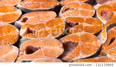 Fresh salmon steak texture background. Salmon red fish steak. Large Pile of trout steak. Big steaks of salmon lined up. Big pieces raw salmon. Fresh salmon steak texture background. Salmon red fish steak. Large Pile of trout steak. Big steaks of salmon lined up. Big pieces raw salmon. 132119969