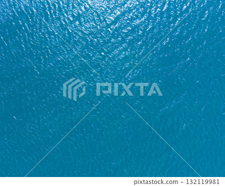 Aerial view of a crystal clear sea water texture. View from above Natural blue background. Blue water reflection. Blue ocean wave. Summer sea. Drone. Top view Aerial view of a crystal clear sea water texture. View from above Natural blue background. Blue water reflection. Blue ocean wave. Summer sea. Drone. Top view 132119981