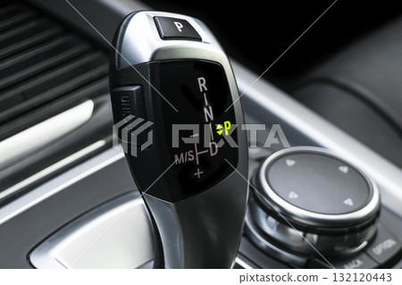 Automatic gear stick of a modern car. Car interior details. Transmission shift. Automatic gear stick of a modern car. Car interior details. Transmission shift. 132120443
