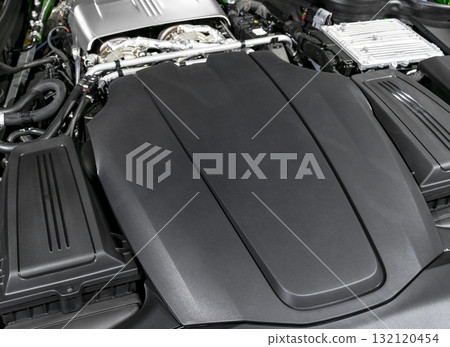 Car gasoline engine. Car engine part. Close-up image of an internal combustion engine. Engine detailing in a new car. Car gasoline engine. Car engine part. Close-up image of an internal combustion engine. Engine detailing in a new car. 132120454