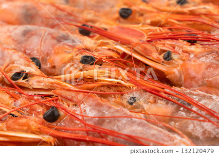 Raw frozen shrimp background. Pile of frozen shrimps. Close-up of frozen shrimps. A lot of royal shrimp macro shot. Red giant argentine shrimp texture background. Large tiger shrimp Raw frozen shrimp background. Pile of frozen shrimps. Close-up of frozen shrimps. A lot of royal shrimp macro shot. Red giant argentine shrimp texture background. Large tiger shrimp 132120479