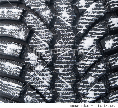 Winter studded tire background. Winter car tires texture background with snow. Tire stack background. Tyre protector surface. Square powerful spikes. Winter studded tire background. Winter car tires texture background with snow. Tire stack background. Tyre protector surface. Square powerful spikes. 132120489