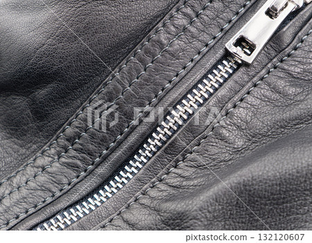 Macro shot of zipper on black leather texture background with stitching. Close-up of black leather material 132120607