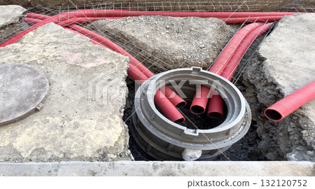 Installation of a sewage plastic pipe during the construction. Street reconstruction site with plastic sewage pipes. Building construction site with engineering pipeline drainage technology Installation of a sewage plastic pipe during the construction. Street reconstruction site with plastic sewage pipes. Building construction site with engineering pipeline drainage technology 132120752