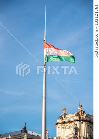Huge hungarian flag waving from a Parliament building in Budapest, Hungary Huge hungarian flag waving from a Parliament building in Budapest, Hungary 132121361