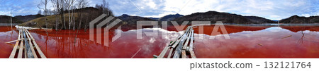Panorama of red cyanide mining residuals flowing in decanting pond 132121764