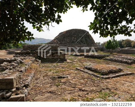Dharmarajika stupa and ruins in Taxila Pakistan showing ancient Buddhist heritage remains and stone architecture of Gandhara Dharmarajika stupa and ruins in Taxila Pakistan showing ancient Buddhist heritage remains and stone architecture of Gandhara 132122259