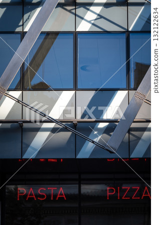 Modern Building with Neon Pasta and Pizza Signs 132122634