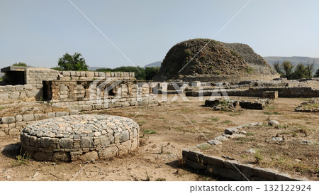 Small votive stupas at Dharmarajika ruins built by devotees to fulfill wishes and express gratitude Small votive stupas at Dharmarajika ruins built by devotees to fulfill wishes and express gratitude 132122924