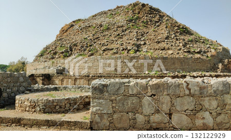 Majestic Dharmarajika Stupa panoramic landscape showcasing UNESCO World Heritage Buddhist monument in Taxila Majestic Dharmarajika Stupa panoramic landscape showcasing UNESCO World Heritage Buddhist monument in Taxila 132122929