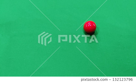 A single red snooker ball resting on a green baize snooker table surface A single red snooker ball resting on a green baize snooker table surface 132123796
