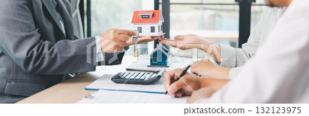 Panorama view of business meeting with miniature house model on desk, real estate contract signing, property investment, mortgage loan agreement and financial planning concept. mortgage loan agreement 132123975