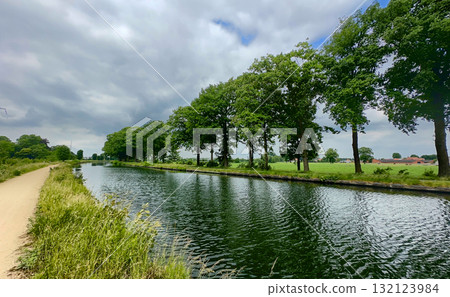 A Serene and Picturesque Canal Landscape Surrounded by Lush, Green, Abundant Trees and Nature A Serene and Picturesque Canal Landscape Surrounded by Lush, Green, Abundant Trees and Nature 132123984