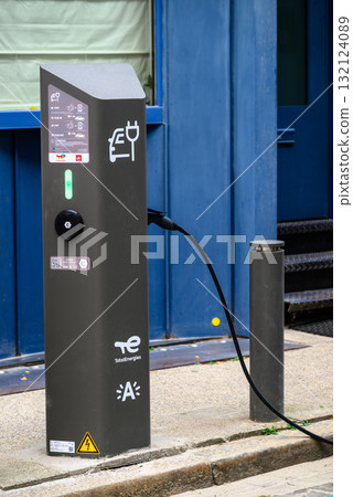 Electric vehicle charging station with plug symbol and LED indicators on a street in Antwerp, Belgium Electric vehicle charging station with plug symbol and LED indicators on a street in Antwerp, Belgium 132124089
