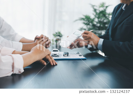 Businessman explaining car loan agreement with calculator, customer discussing auto finance deal at office desk with toy car and document, concept of vehicle loan, insurance or car leasing. car loan. Businessman explaining car loan agreement with calculator, customer discussing auto finance deal at office desk with toy car and document, concept of vehicle loan, insurance or car leasing. car loan. 132124237