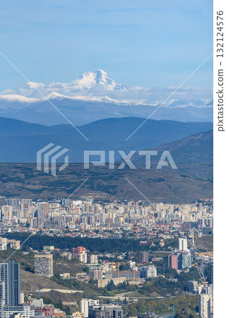 Cityscape view of Tbilisi, the capital of Georgia with snow-capped Caucasus mountains in the distance 132124576