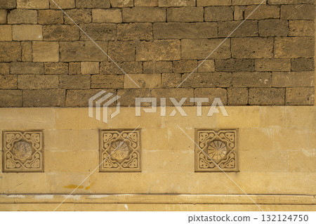 some bas-reliefs on a brick wall in Baku, Azerbaijan 132124750