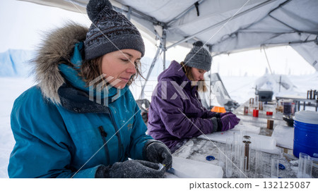 Permafrost scientists examining core samples in field lab tents Life in permafrost conditions, climate change problems on the planet. Global warming Permafrost scientists examining core samples in field lab tents Life in permafrost conditions, climate change problems on the planet. Global warming 132125087