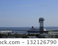 With a clear blue sky in the background, the Blue Impulse flies over the Marine Tower and a large passenger ship in Oarai, Ibaraki Prefecture, spewing smoke. 132126790
