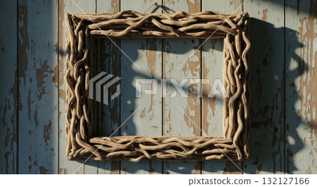 Rectangular frame crafted from weathered gnarled driftwood hanging on a rustic blue wooden wall Rectangular frame crafted from weathered gnarled driftwood hanging on a rustic blue wooden wall 132127166