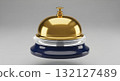Polished gold service bell with deep navy blue base and translucent ring on grey 132127489