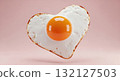 Heart shaped fried egg with a perfectly spherical yolk floating on a pink background 132127503