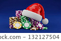 Festive christmas casino scene with a red santa hat resting on colorful poker chips 132127504