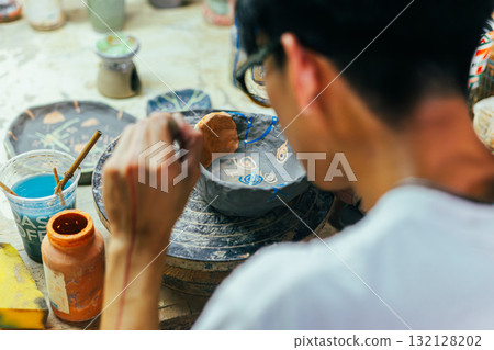 Hand Painting Ceramic Pot in Art Workshop 132128202