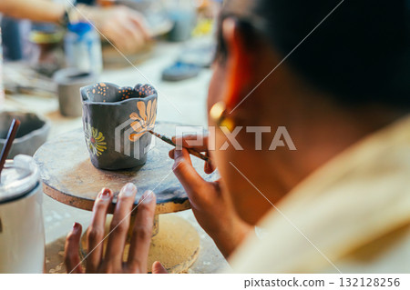Hand Painting Ceramic Pot in Art Workshop Hand Painting Ceramic Pot in Art Workshop 132128256