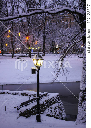 Scenic view of Old Riga in snowy wintertime. Street lanterns. Scenic view of Old Riga in snowy wintertime. Street lanterns. 132128837